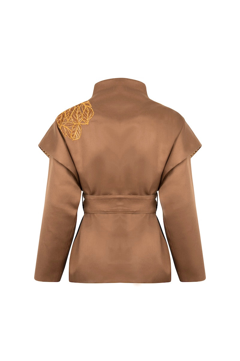 Ecru belted jacket by Nadya Shah featuring a blouson style, shown from the back with a tied waist and relaxed fit.