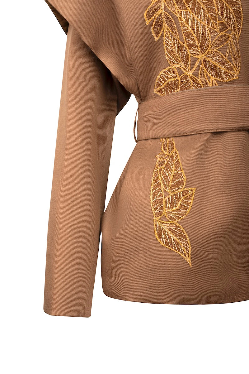 Ecru belted jacket by Nadya Shah featuring a relaxed fit and side details, styled as a versatile women's outerwear piece.