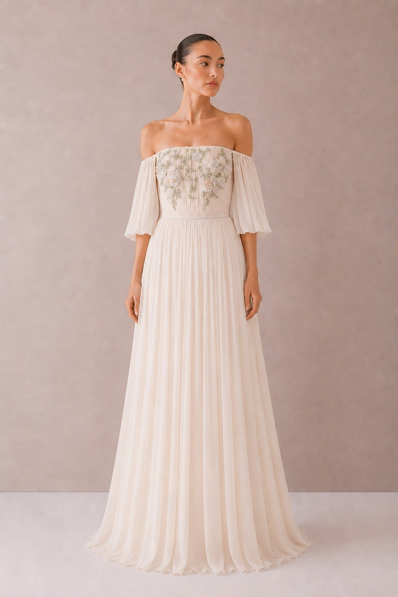 Nihan Peker Juliette gown in vanilla with elegant flowing fabric and delicate detailing, perfect for formal occasions.
