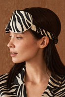 Silk eye mask with jungle zebra print by MANITO, featuring a stylish zebra pattern for comfort and sleep aid.