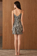 Woman wearing a silk chemise with jungle zebra print, stylish nightgown by MANITO featuring a vibrant zebra pattern.