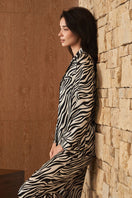 Women's silk pajama set with jungle zebra print from MANITO, featuring a relaxed fit and elegant zebra pattern.