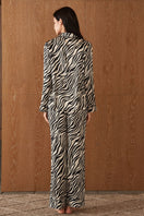 Women's silk pajama set with jungle zebra print by MANITO, featuring a comfortable top and matching pants in bold zebra design.
