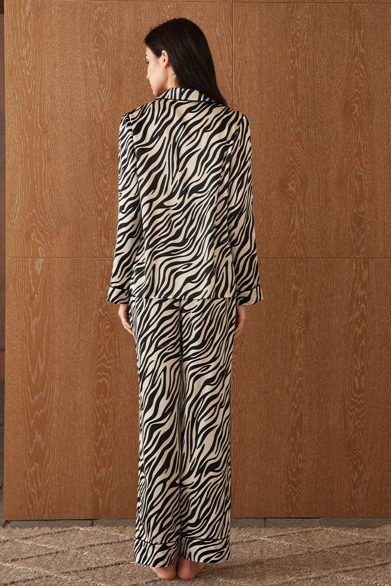 Women's silk pajama set with jungle zebra print by MANITO, featuring a comfortable top and matching pants in bold zebra design.