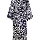Woman wearing a MANITO jungle zebra print silk robe, featuring a stylish zebra pattern and luxurious silky fabric.