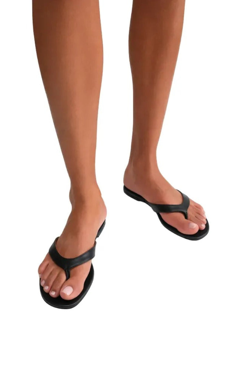 Black Kolane Rio sandals featuring sleek straps and a comfortable flat sole, perfect for casual summer wear.