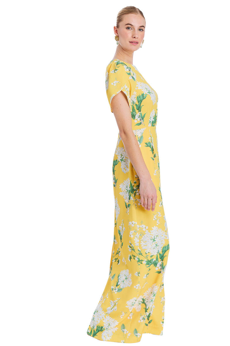 Yellow-green Katherine gown by Mestiza New York, flowing fabric with elegant drape and intricate details.