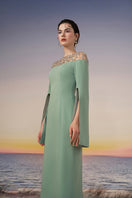 Mint green Calypso crepe gown by 21Six, flowing design with elegant drape, suitable for formal occasions.