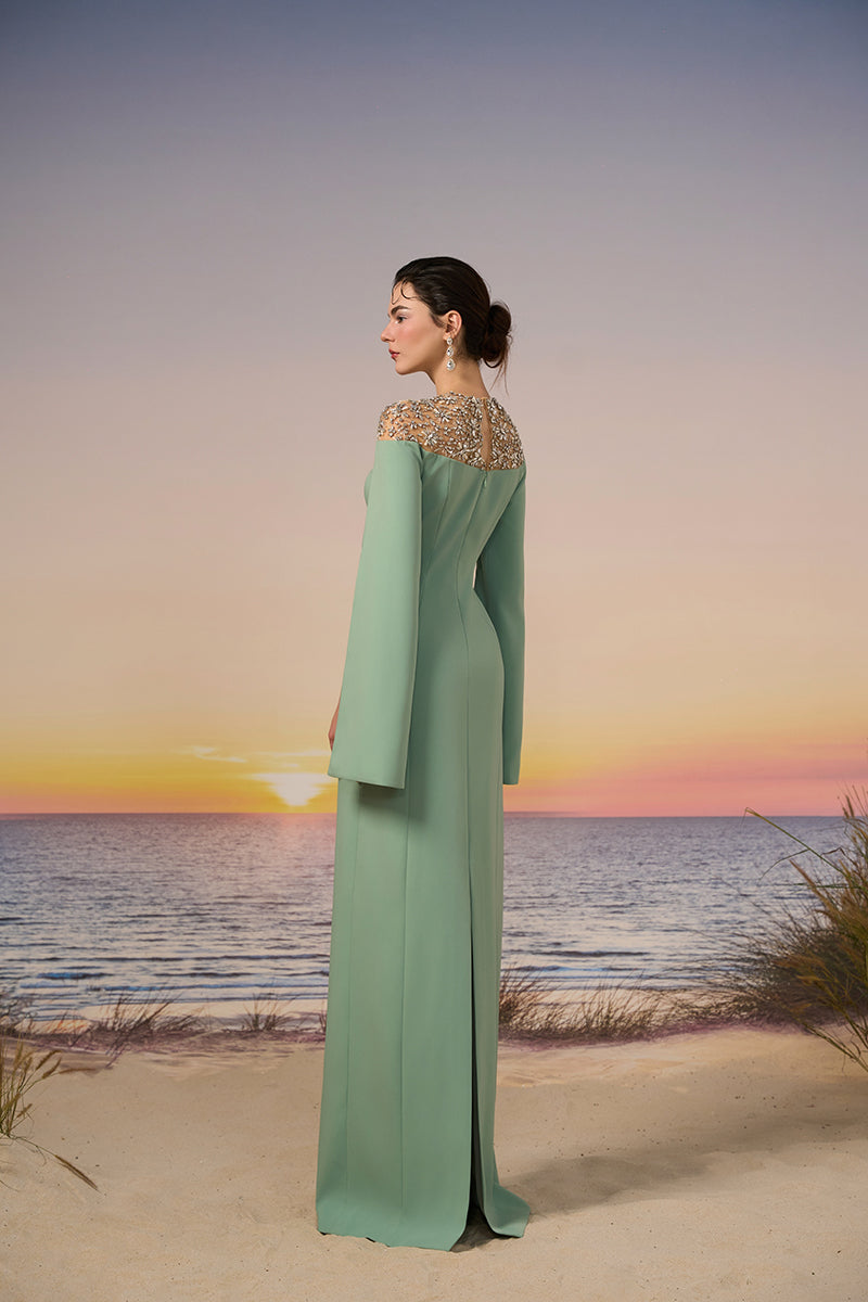 Mint green Calypso crepe gown by 21Six, featuring elegant fabric and flowing silhouette, styled with subtle draping and a fitted waist.
