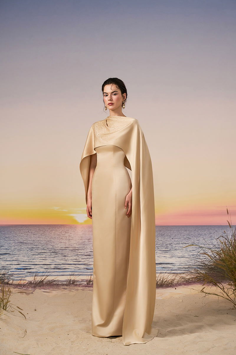 Beige CULT MIA X 21Six Nala silk satin gown with a flowing design, featuring elegant draping and a smooth, shiny finish.