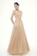 Beige Grace tulle gown by 21Six, featuring elegant flowy fabric and delicate detailing, perfect for formal occasions.