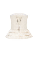 Creamy white Dranka corset top by Podyh, featuring a fitted design and structured detailing, displayed on a neutral background.