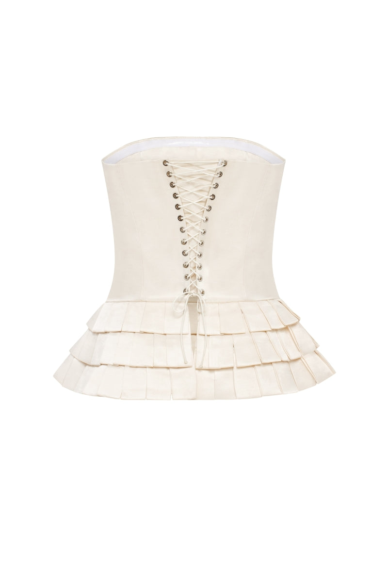 Creamy white Dranka corset top by Podyh, featuring a fitted design and structured detailing, displayed on a neutral background.