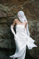 PODYH Tympan midi dress in eggshell color with elegant, flowing fabric and classic design, perfect for stylish occasions.