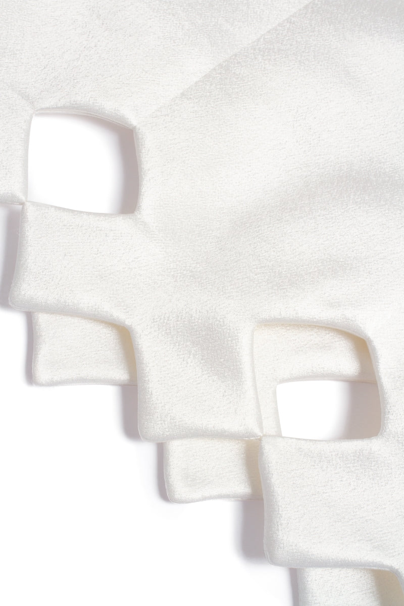 PODYH Tyman eggshell midi dress displayed on a hanger, showcasing its elegant design and soft fabric in a neutral color.