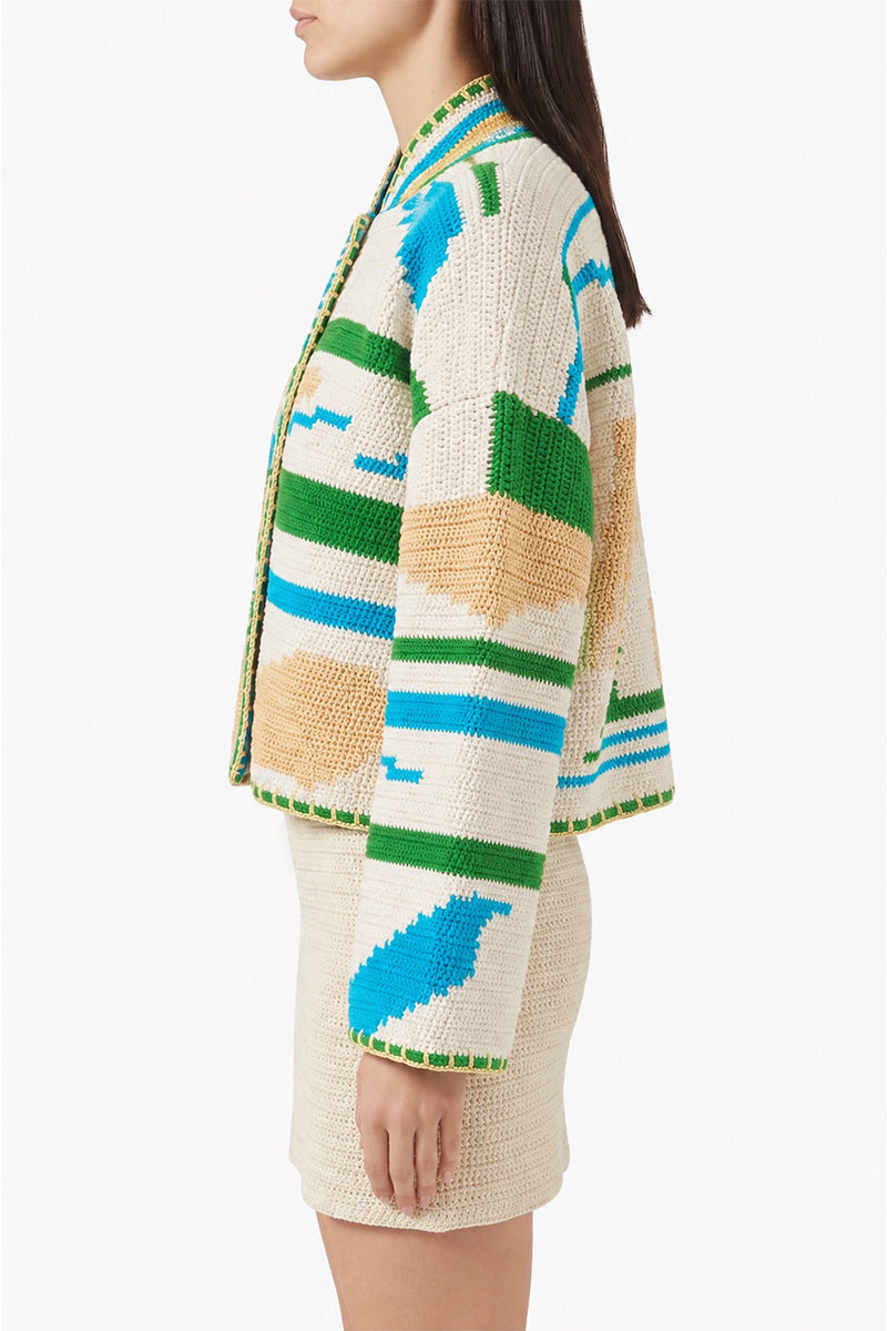 Jessica K Kiona cardigan in beige and green, featuring a cozy knit design, shown on a neutral background.