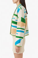 Jessica K Kiona beige and green cardigan jacket, soft knit fabric with button details, styled on a model.