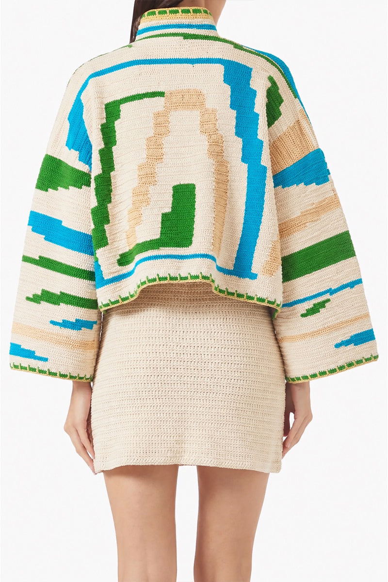 Jessica K Kiona cardigan in beige and green, featuring a cozy knit design, displayed on a neutral background.