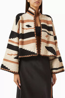 Jessica K Kiona cardigan in camel and black, featuring a soft knit fabric and stylish design, worn as a versatile layering piece.