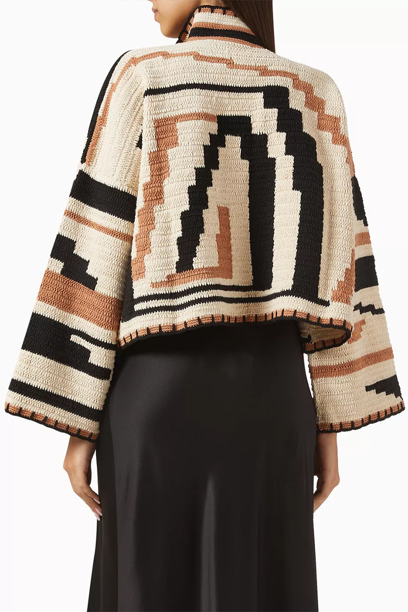 Jessica K Kiona cardigan in camel and black, featuring a cozy knit design and button closure, displayed on a neutral background.