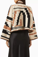 Jessica K Kiona cardigan in camel and black, stylish knitwear with a soft texture and button closure, displayed on a hanger.