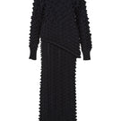 Black knitted co-ord set featuring a sweater and skirt by MAZ Manuela Álvarez, styled together in a coordinated ensemble.