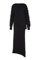 Black knitted co-ord set featuring a sweater and skirt by MAZ Manuela Álvarez, styled together in a coordinated ensemble.