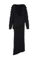 Black knitted co-ord set by MAZ Manuela Álvarez featuring a fitted sweater and matching skirt.