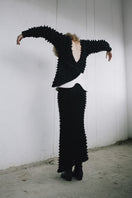Black knitted co-ord set featuring a sweater and skirt from MAZ Manuela Álvarez with cozy, stylish knit fabric.