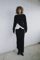 Black knitted co-ord set featuring a sweater and skirt from MAZ Manuela Álvarez, styled together for a cozy, fashionable look.