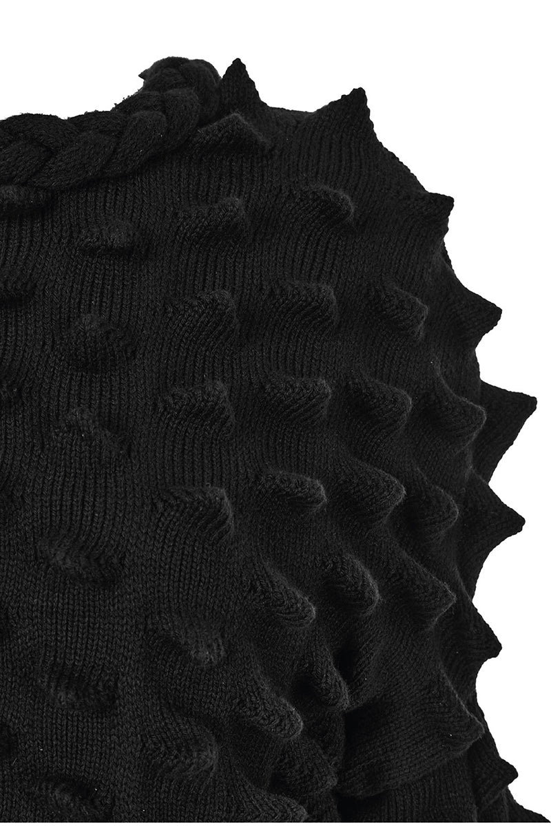Knitted Peaks sweater by MAZ Manuela Álvarez featuring a cozy, textured knit design in neutral tones.