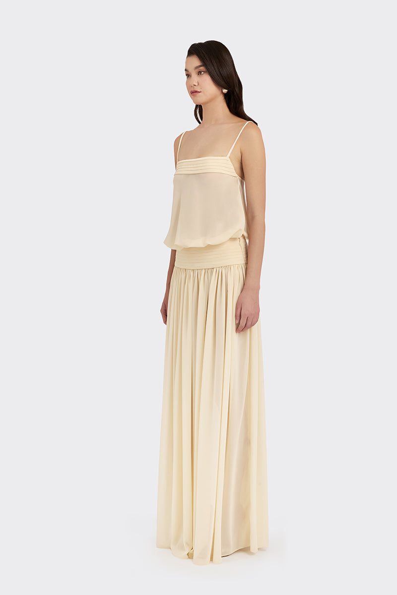 Beige KAIA satin maxi dress by Stolen Stores, flowing chiffon fabric with elegant design, displayed on a hanger.