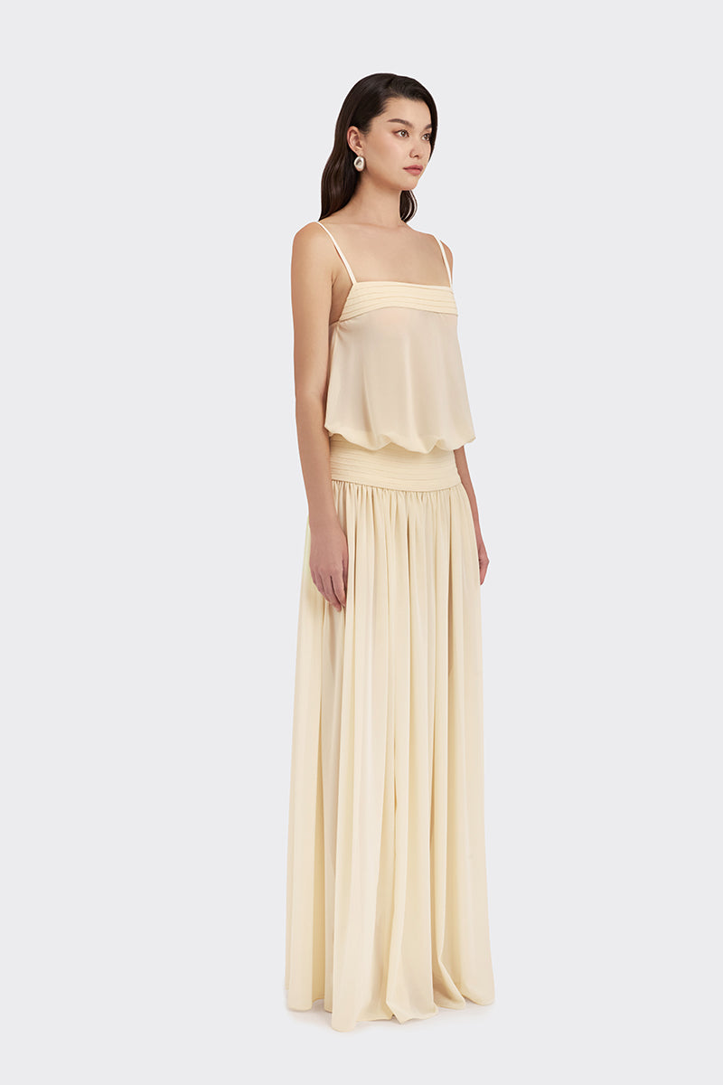 Beige KAIA satin maxi dress by Stolen Stores, flowing chiffon fabric and elegant design, displayed on a hanger.