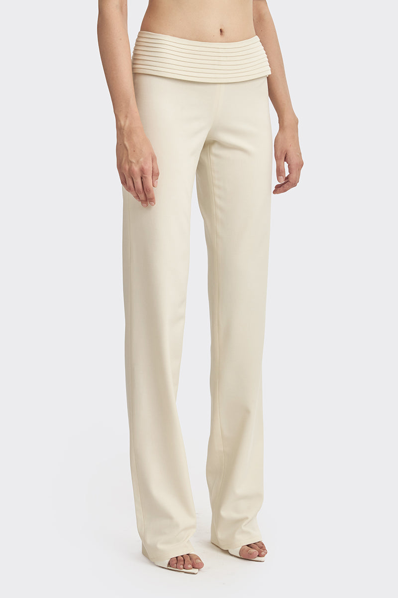 Off-white KAIA pants from Stolen Stores featuring a relaxed fit, soft fabric, and minimalist style, shown in a full-length view.