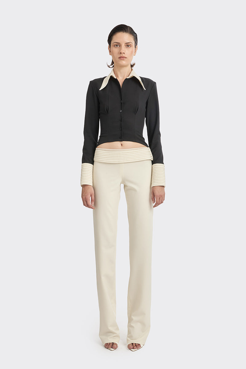 Black KAIA shirt from Stolen Stores, a stylish women's top with a modern design and contrasting white accents.