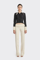 Black KAIA shirt from Stolen Stores, a stylish women's top with a modern design and contrasting white accents.