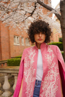 Nadya Shah Kai in Seville jacket featuring a stylish, lightweight cape design with intricate patterns and vibrant colors.