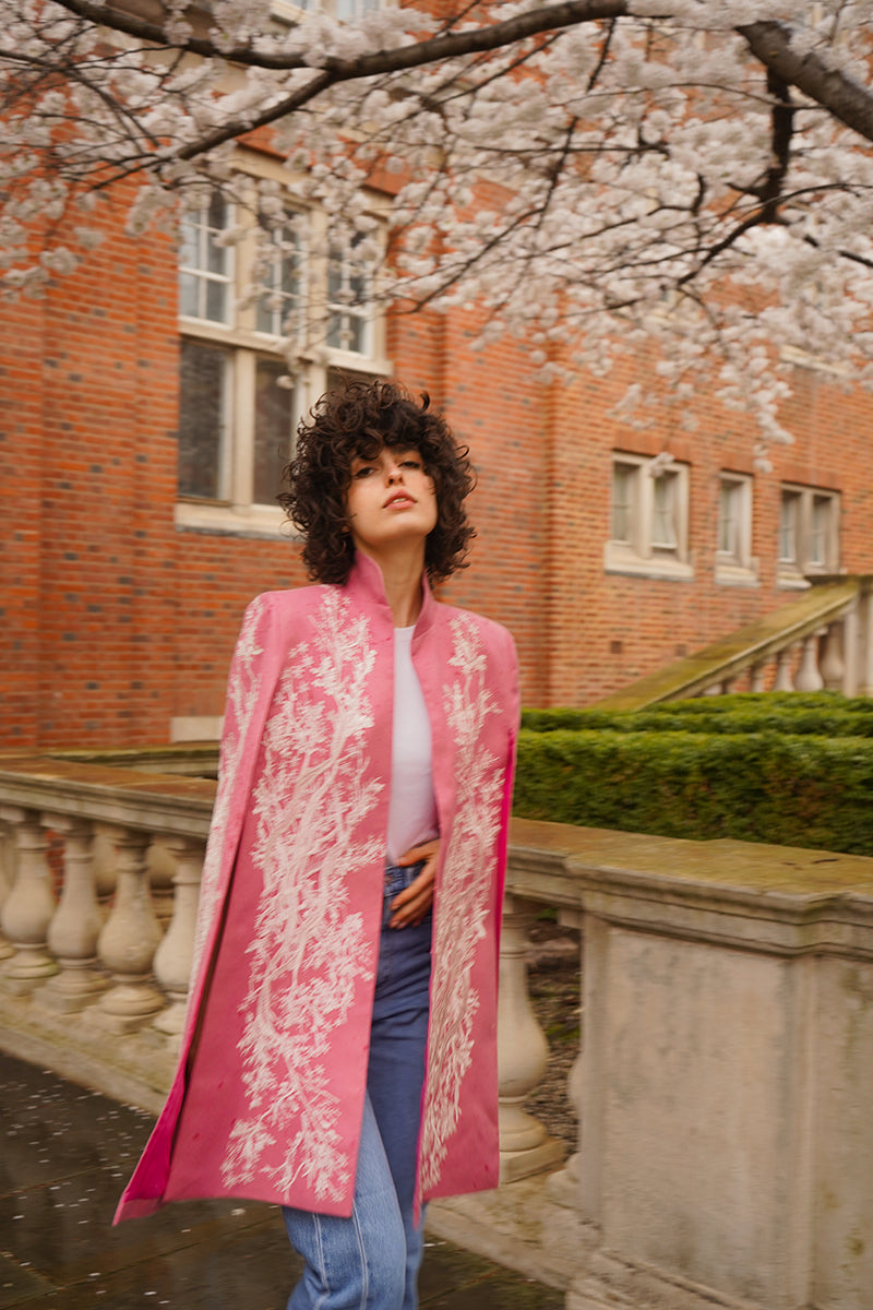 Nadya Shah KAI IN SEVILLE jacket displayed on a hanger, featuring a stylish design with intricate details and a tailored fit.