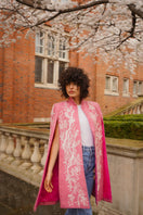 Nadya Shah KAI IN SEVILLE jacket displayed on a hanger, showcasing its stylish design and fabric details.