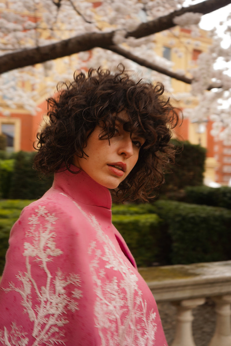 Nadya Shah KAI IN SEVILLE jacket featuring a stylish cape design, shown in a close-up view of the jacket's fabric and details.