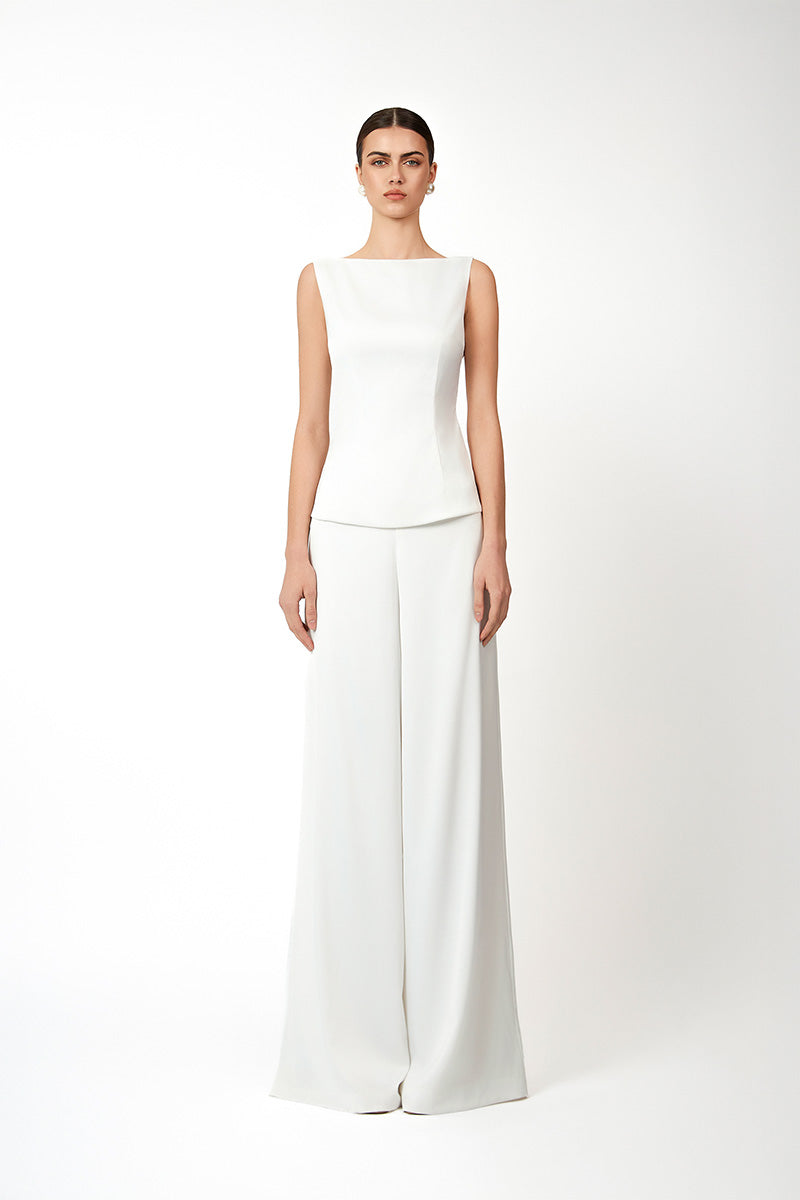 White KASTRID top by Khanum's, showcasing a stylish sleeveless design with a smooth fabric finish.