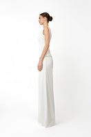 White KASTRID top by Khanum's, featuring a stylish design, shown on a model with detailed fabric and neckline visible.