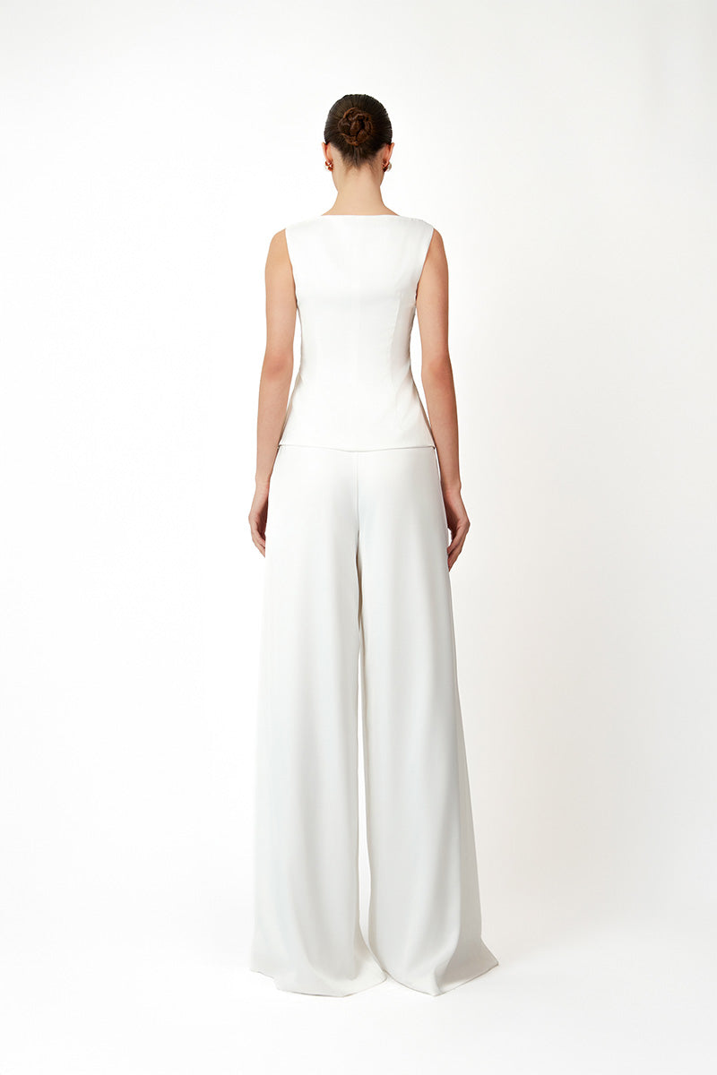 White KASTRID top by Khanum's, featuring a stylish and comfortable design, shown on a model with detailed fabric texture.
