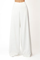 White KASTRID Pants by Khanum's featuring a relaxed fit and sleek design, shown on a model in the product image.
