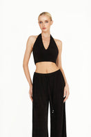 Black Kayla co-ord set by Khanum's featuring a fitted top and matching pants, styled for a modern, chic look.