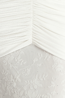 Close-up of Khanum's Kaylin white maxi gown showing elegant fabric details and neckline design.