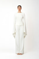 White Khanum's pants with a tailored fit, displayed on a hanger against a neutral background.