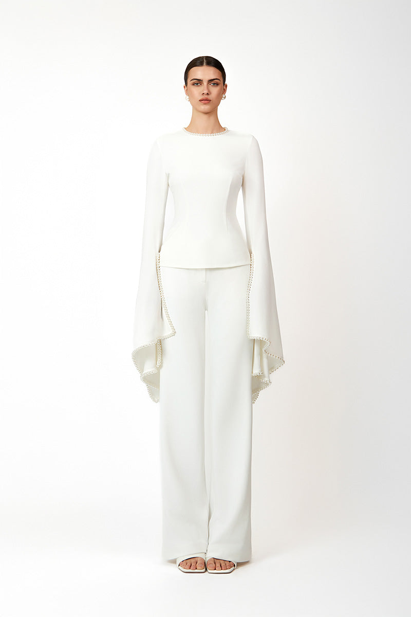 White Khanum's pants with a tailored fit, displayed on a hanger against a neutral background.