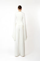 White Khanum's pants with a tailored fit, displayed on a hanger against a neutral background.
