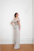 Silver keepsake gown by Yassmin Saleh, showcasing the elegant back design with intricate details and flowing fabric.
